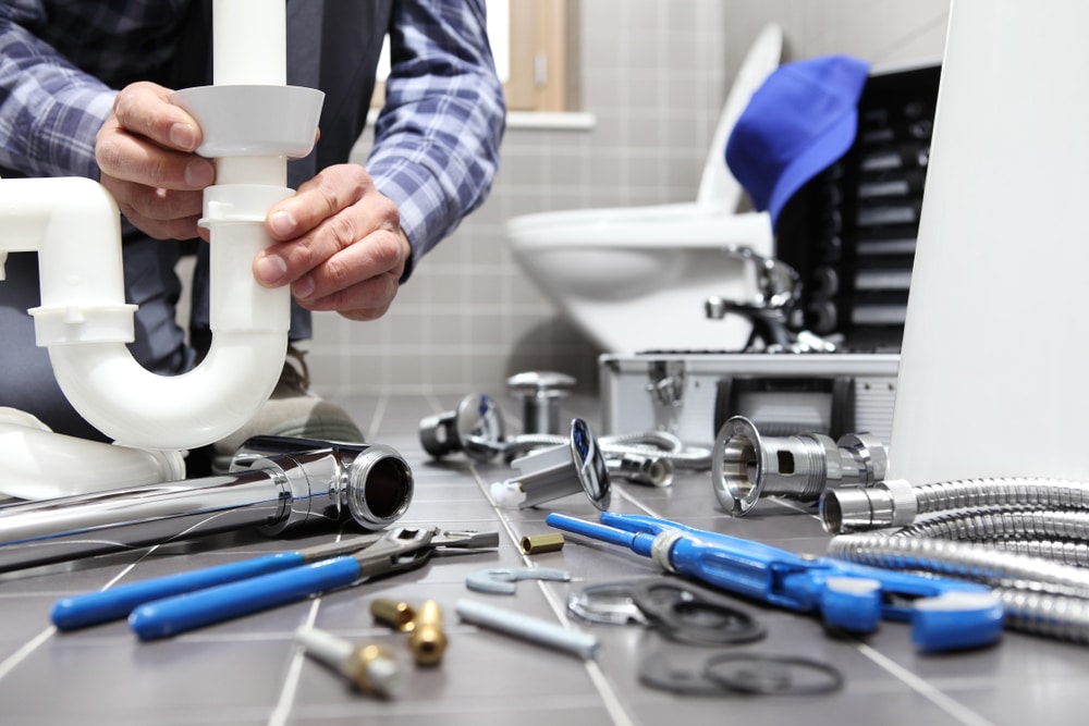 Plumbing repair and installation with tools and pipes for residential plumbing services.