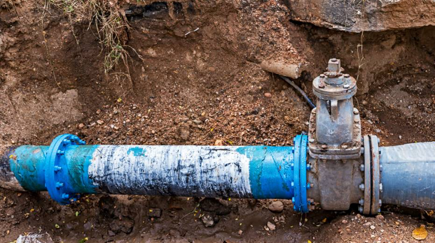 Exposed blue sewer pipe with valve and couplings during Simi Valley sewer line repair.